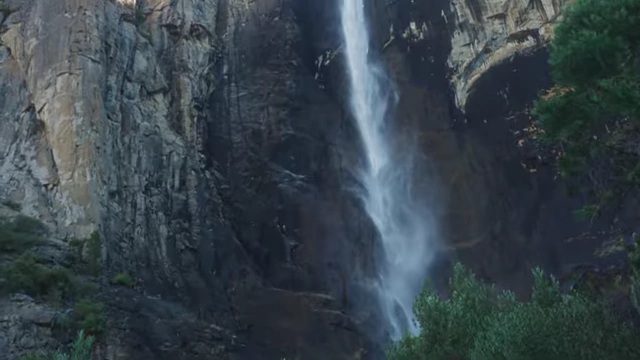 A close-up view of a waterfall cascading down a sheer rock face