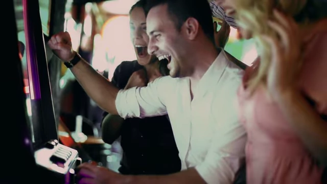 People excitedly celebrating a win at a slot machine