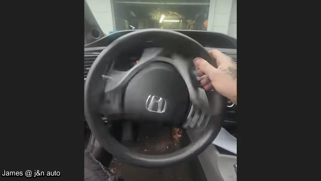 A hand demonstrating the extreme looseness and play in a steering wheel.
