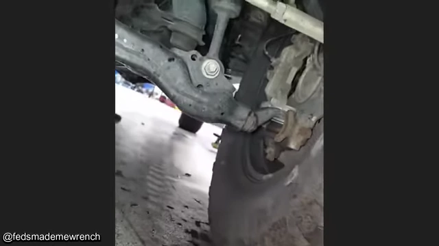 A front tire with minimal wheel weights, contributing to imbalance and vibration.