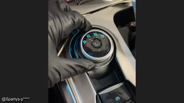 A hand demonstrating the ease with which a broken rotary shift knob can be removed.