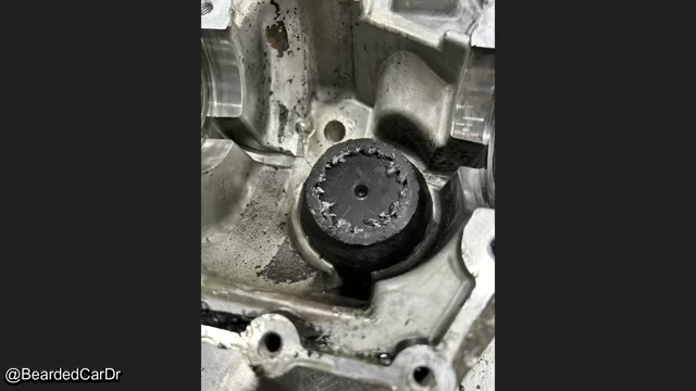 Severely damaged and shredded differential gears from a vehicle.