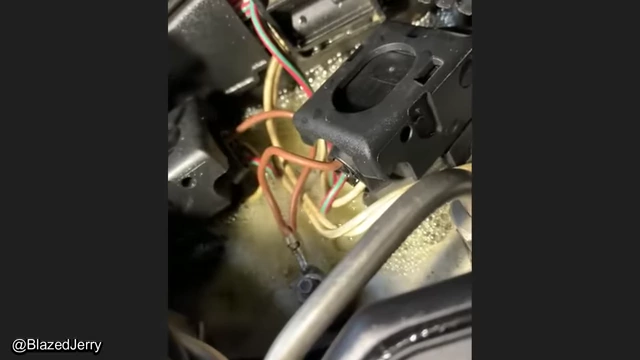 A close-up view of a leaking fuel injector, surrounded by evidence of previous, possibly faulty, repair work.
