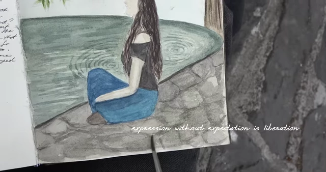 A journal sketch depicting a person by the water, emphasizing 'expression without expectation is liberation'.