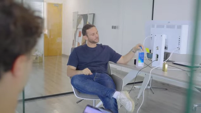 A team member pointing at detailed data on a monitor, illustrating the focus on analytics and data-driven decision-making