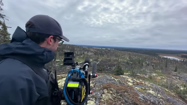 Filmmaker filming with a camera on a mountain