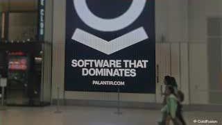 A billboard displaying Palantir's logo and the slogan "SOFTWARE THAT DOMINATES."