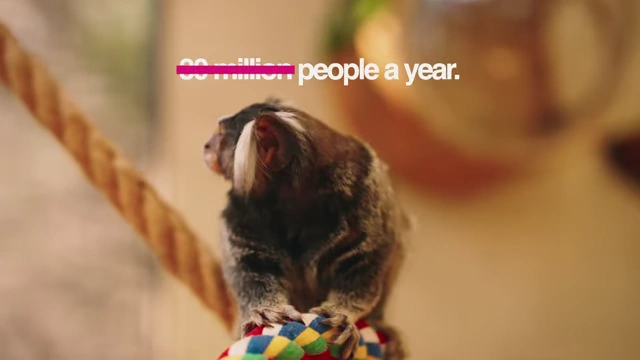 Screen overlay indicating a reach of "100 million people a year."