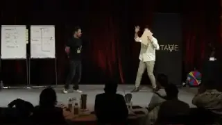 This image shows the speaker demonstrating to Raj Shamani how to improve his stage presence.