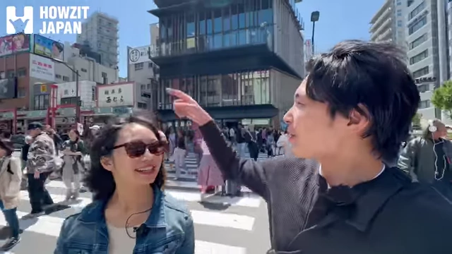 Speaker pointing to the Asahi Beer building