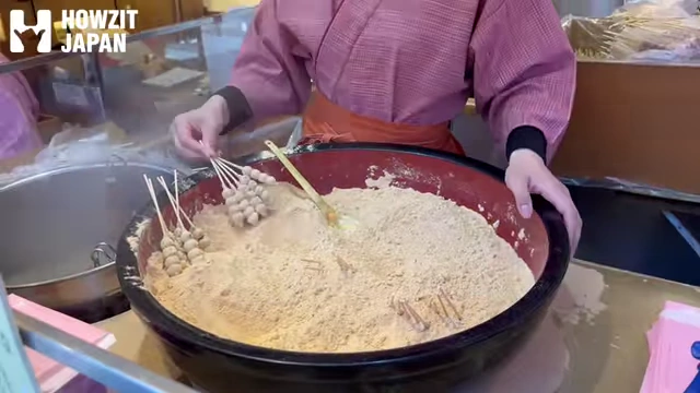 Kibi Dango being made, covered in kinako powder