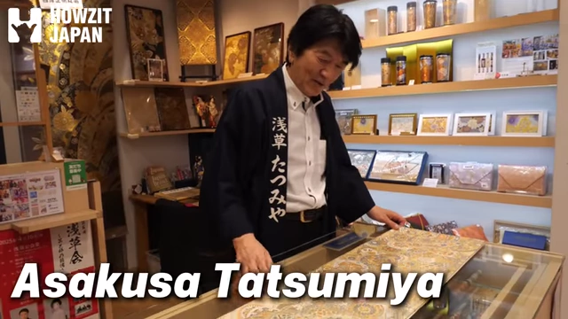 Shop owner showcasing a kimono tenugui fabric