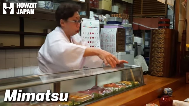 Sushi chef preparing dishes at Mimatsu