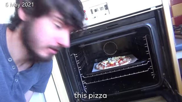 A pizza with too much onion being baked in an oven.