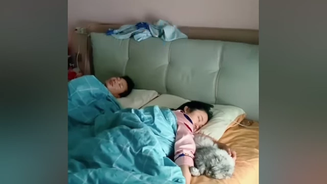 A couple 'bed rotting' together, highlighting the trend's communal aspect.