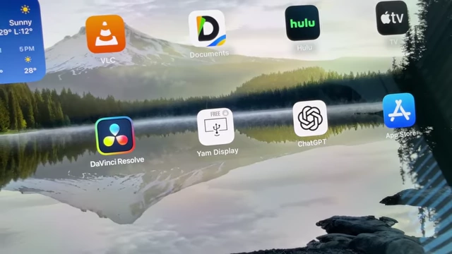A close-up of the iPad screen showing various app icons, including "Yam Display".