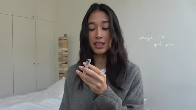 The presenter holding up a Muji 0.38 gel pen.