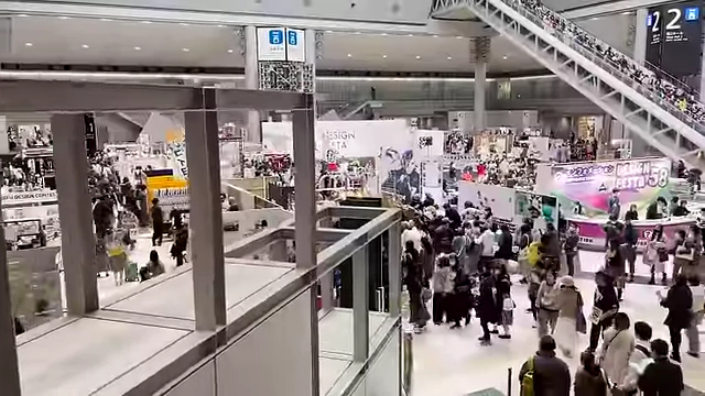 An aerial view of one of Design Festa's halls, bustling with attendees and booths.