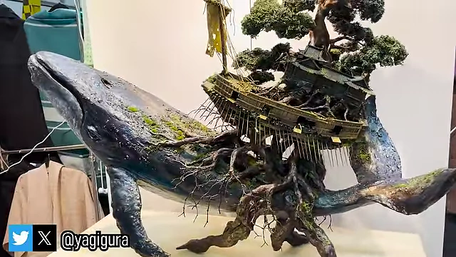 An elaborate sculpture of a whale carrying an ancient, tree-rooted structure.
