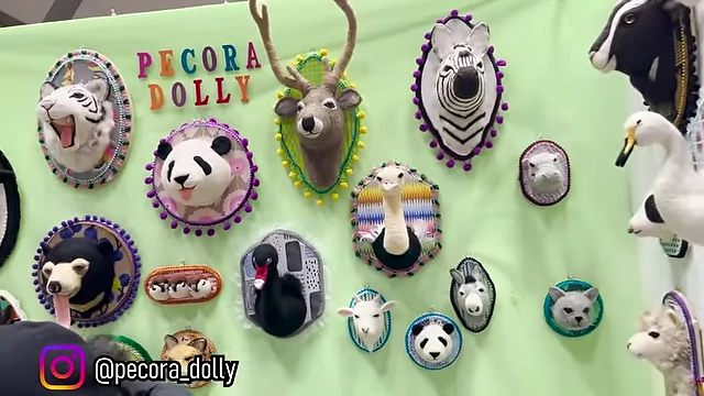 Felted faux animal head mounts, including pandas, deer, and ostriches.