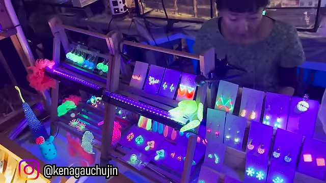 A vibrant display of glow-in-the-dark jewelry, including earrings and necklaces.