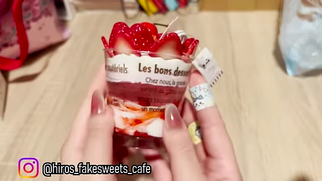 A highly realistic fake strawberry parfait, a decorative art piece.