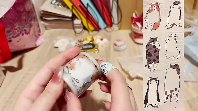 A roll of washi tape featuring whimsical cat illustrations.