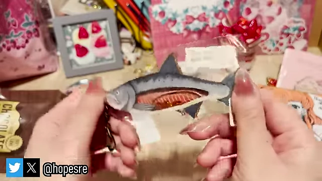 A unique salmon-shaped shaker charm filled with "fish eggs."