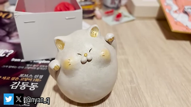 A charming handmade chubby cat figurine, a significant sentimental purchase.