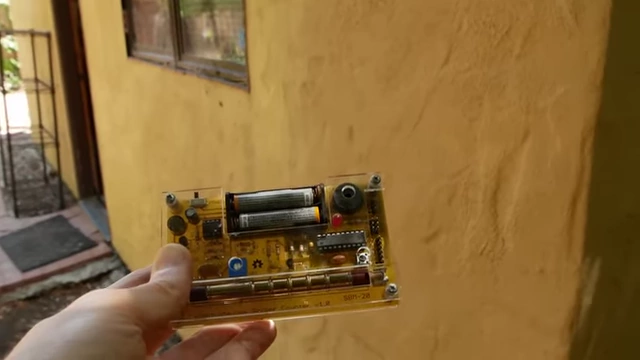 A Geiger counter being used to check for radiation outside the X-ray system's enclosure