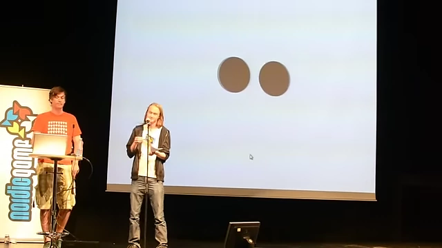 Two brown circles moving towards each other, appearing to merely pass through without sound.