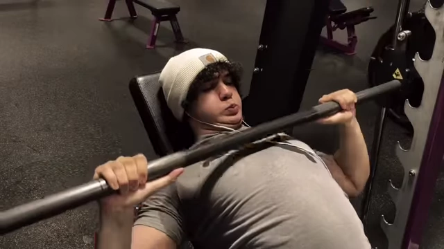 The speaker demonstrating training to failure during a bench press set