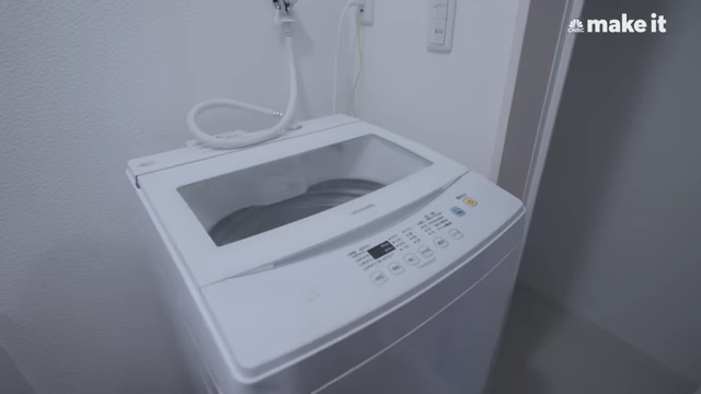 Compact washing machine in Lexi's bathroom area.