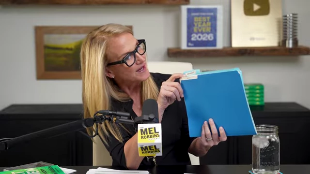 Mel Robbins holding a folder from her 2006 goal-setting, illustrating her 22-year ritual