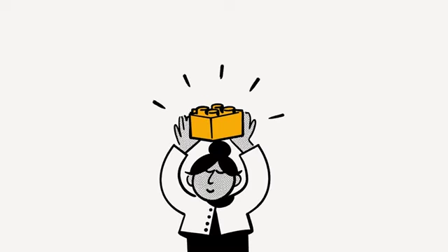 An illustration of a person holding a yellow Lego brick, symbolizing Notion's modular "Lego block" architecture.