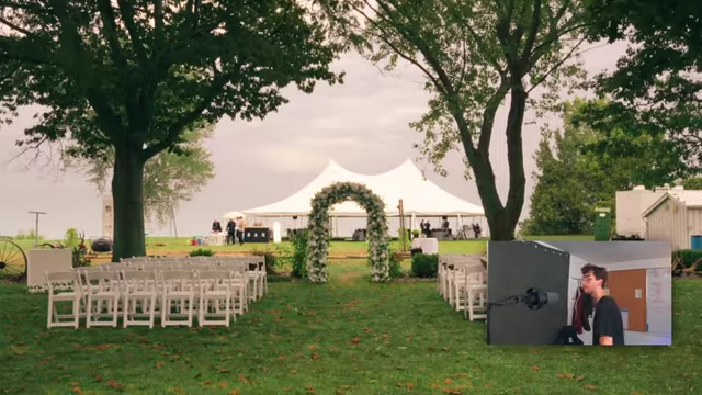A wider shot of the outdoor wedding setup, with a white archway and a large tent in the background.