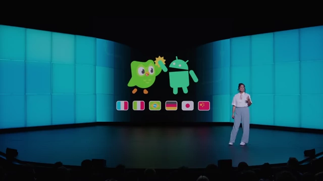 Duolingo Duo high-fiving the Android logo, with flags for upcoming language availability for the Chess course.