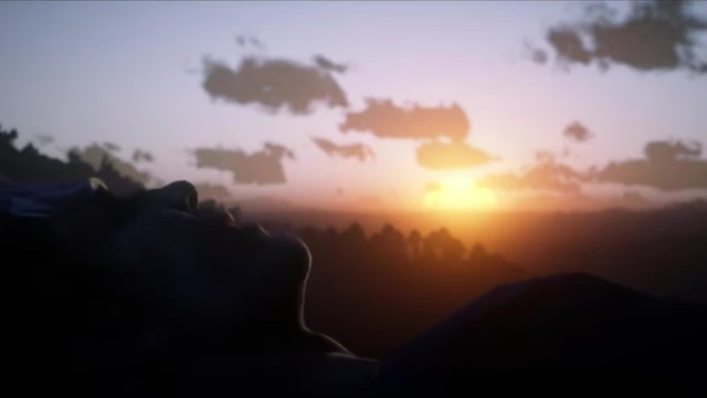 Arthur Morgan lying on the ground, silhouetted against a beautiful sunset in Red Dead Redemption 2.
