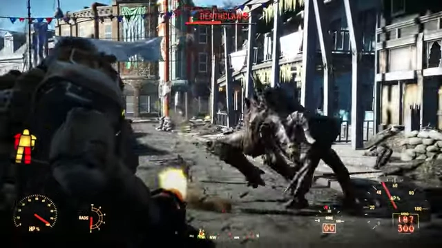 Gameplay from Fallout 4, featuring power armor combat against a Deathclaw in a ruined city.