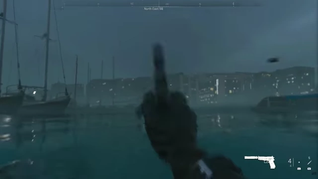First-person gameplay from Call of Duty, showing a character with a pistol in a port environment.