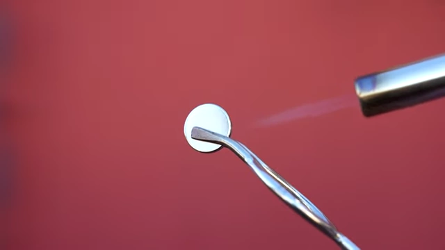 Heating a magnetic screw with a torch until it loses its magnetism