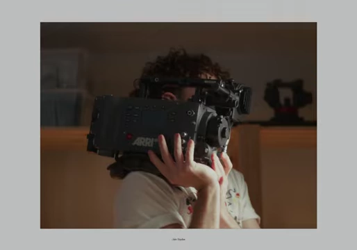 Filmmaker operating the bulky Arri Alexa Classic camera on their shoulder.