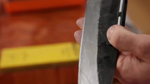 A close-up of a knife blade with a newly polished, sharp edge visible