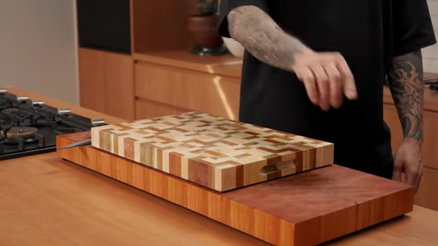 Two distinct cutting boards on a counter, illustrating the separation of boards for raw meat and other foods