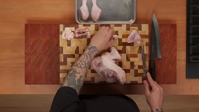 Various cuts of raw chicken—drumsticks, thighs, and wings—arranged on a cutting board