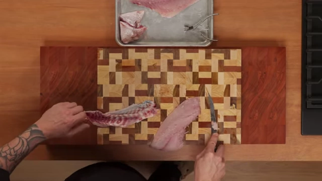 An overhead view of a perfectly skinned fish fillet next to the removed skin