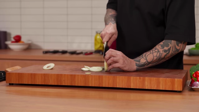 Thin, even onion rings are sliced from a whole onion
