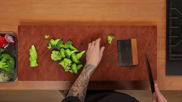 Different sizes of broccoli florets are displayed on a cutting board