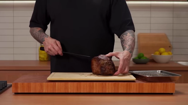 A chef shows the cross-section of a roasted beef joint to identify the grain