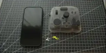 The TourBox Elite Plus, smaller than an iPhone, demonstrating its compact design